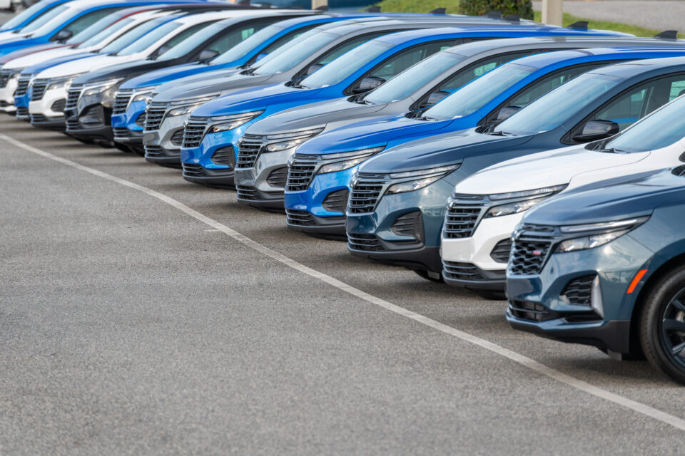 Flotte de véhicules d'entreprise alignés dans un parking, illustrant la gestion et l'optimisation de la mobilité professionnelle.